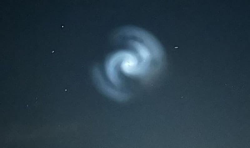 Photograph of golden spiral pattern visible in the sky over New Zealand in March 2025, attributed to a SpaceX launch creating a visible Fibonacci spiral formation
